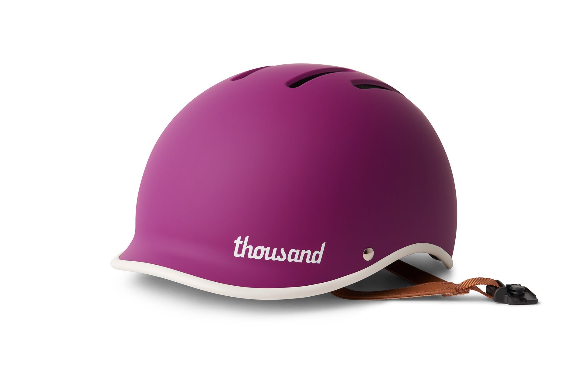 A bright purple helmet with white and black details and a leather strap buckle