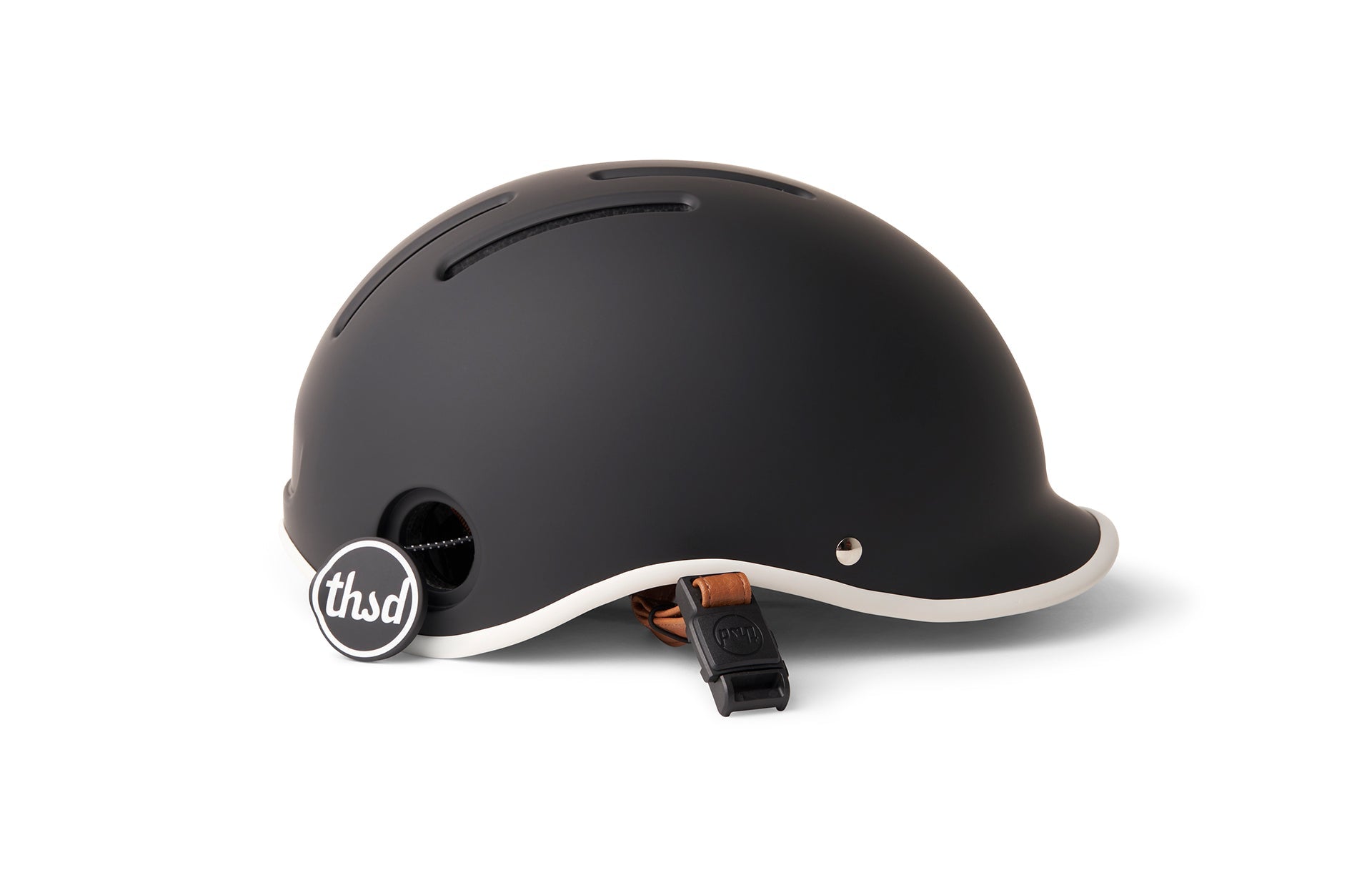 A matte black helmet with white trim, brown strap, and iconic 'thsd' branding displayed on a white background.