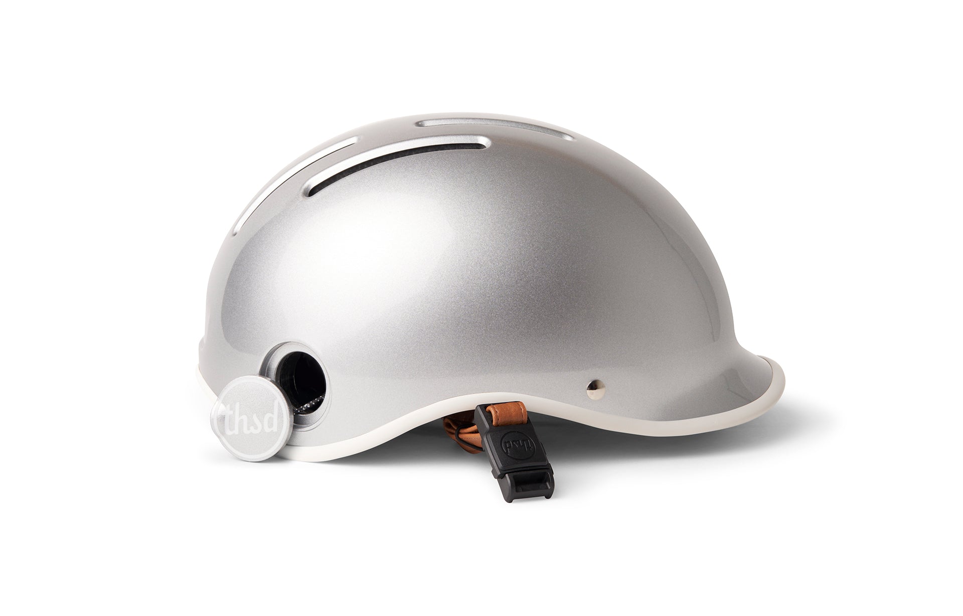 Metallic grey bicycle helmet on a white background with tan leather strap.