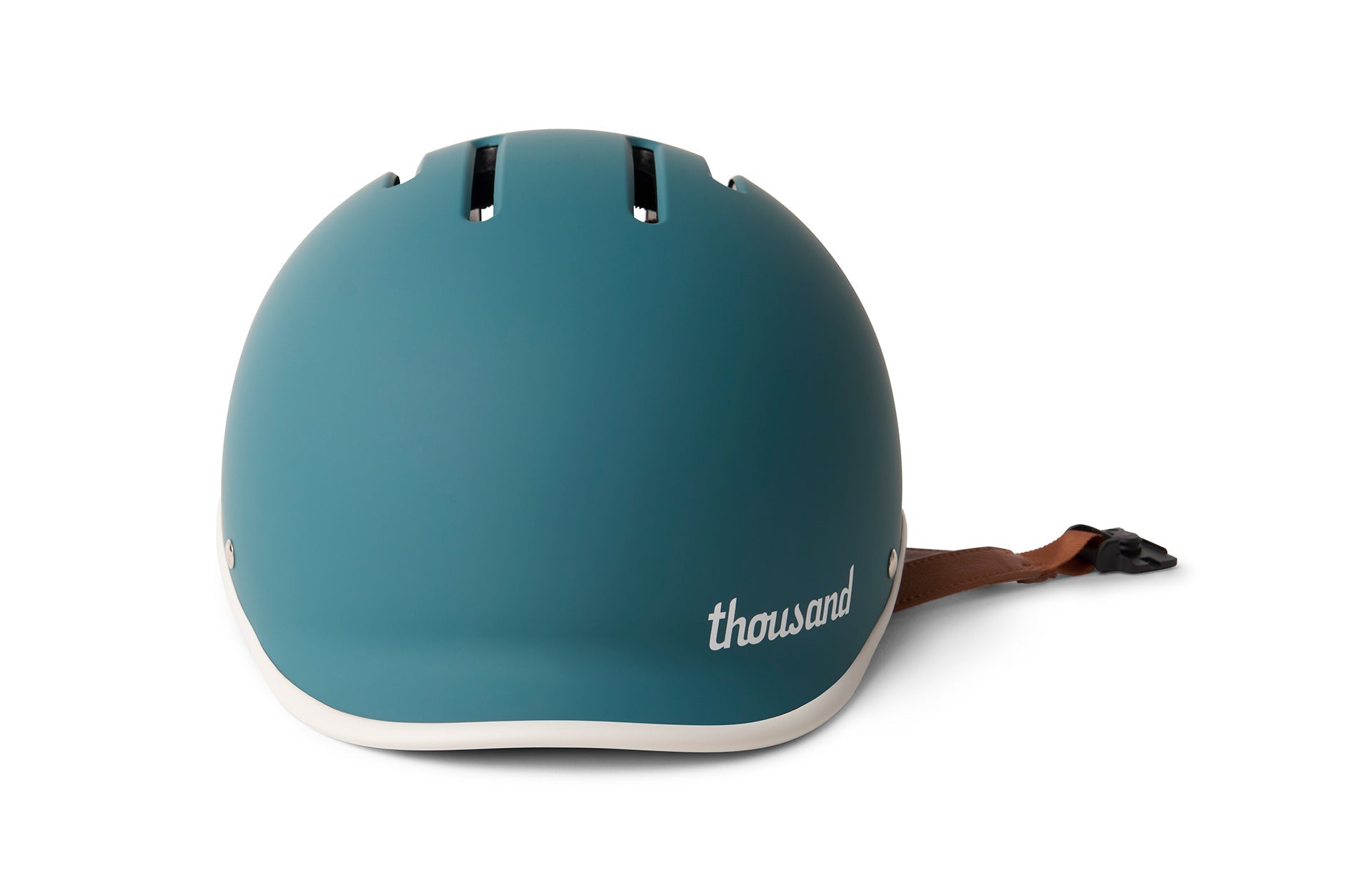 Teal blue thousand bike helmet with a brown strap against white background