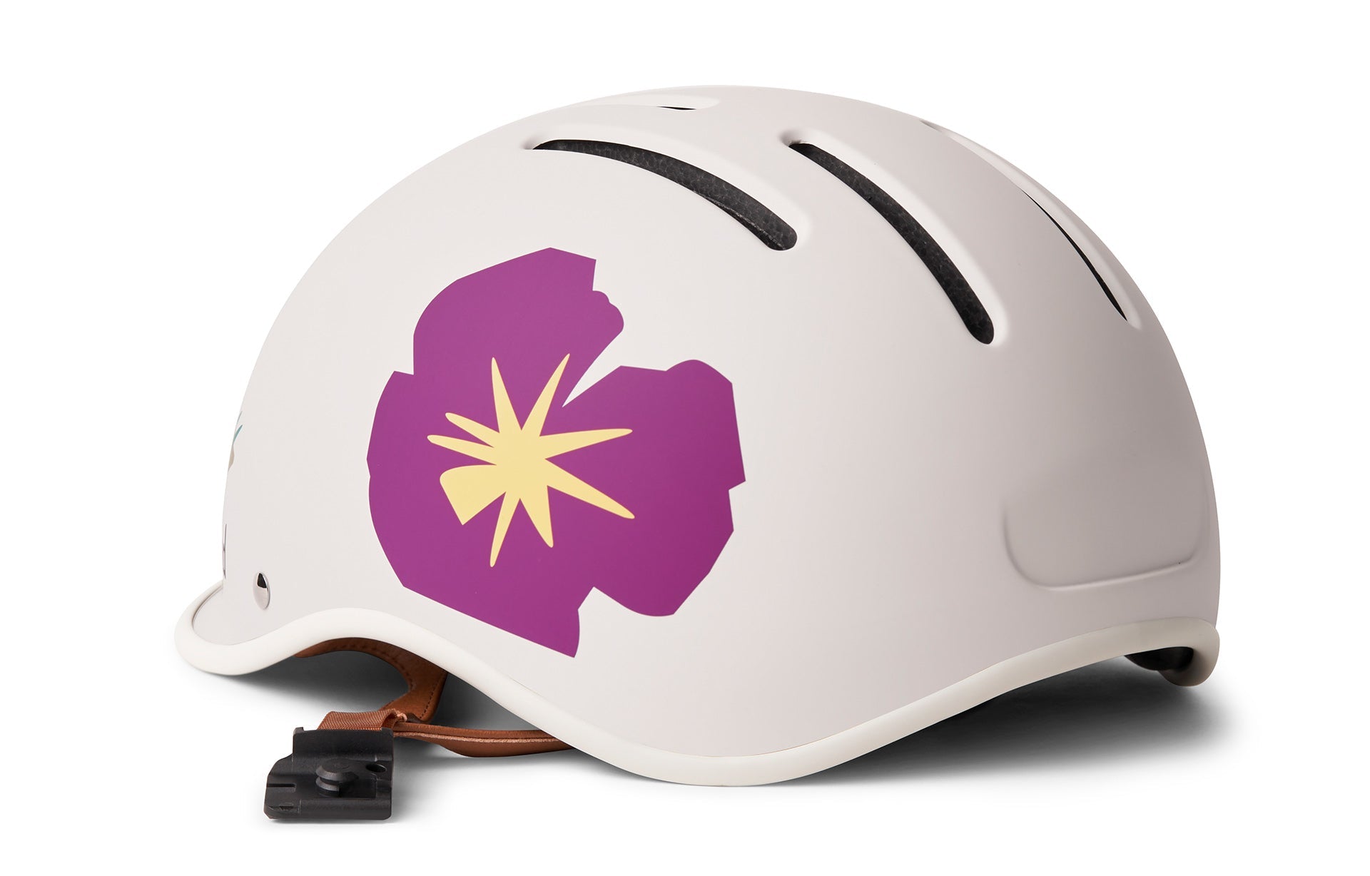 White bicycle helmet with a purple flower design with a yellow star in the middle