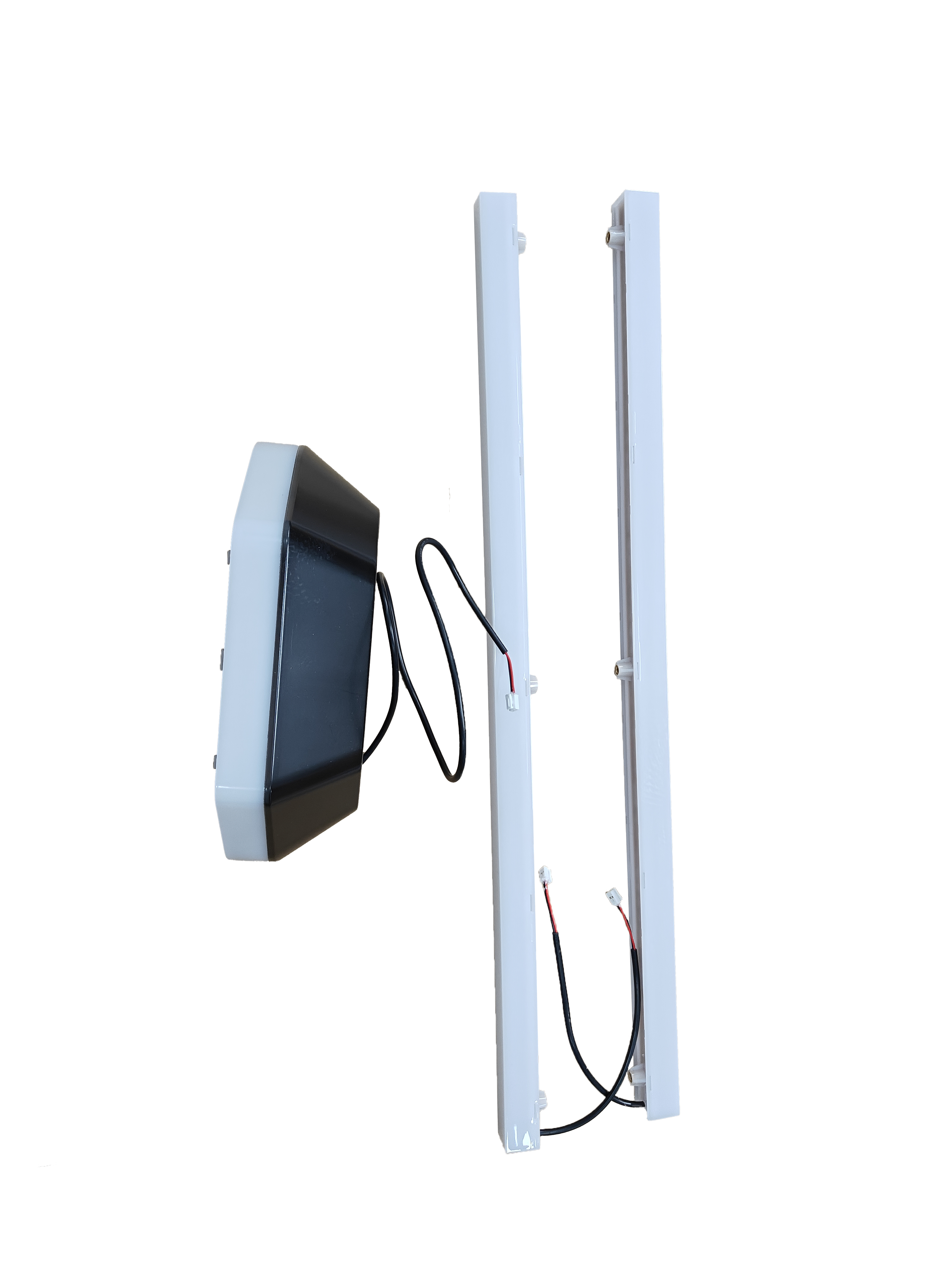 A close up view of two rectangular LED light fixtures, along side a control module on a white backdrop.