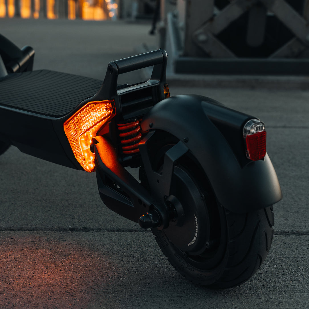 The rear lights illuminated on the Apollo City long range electric scooter.