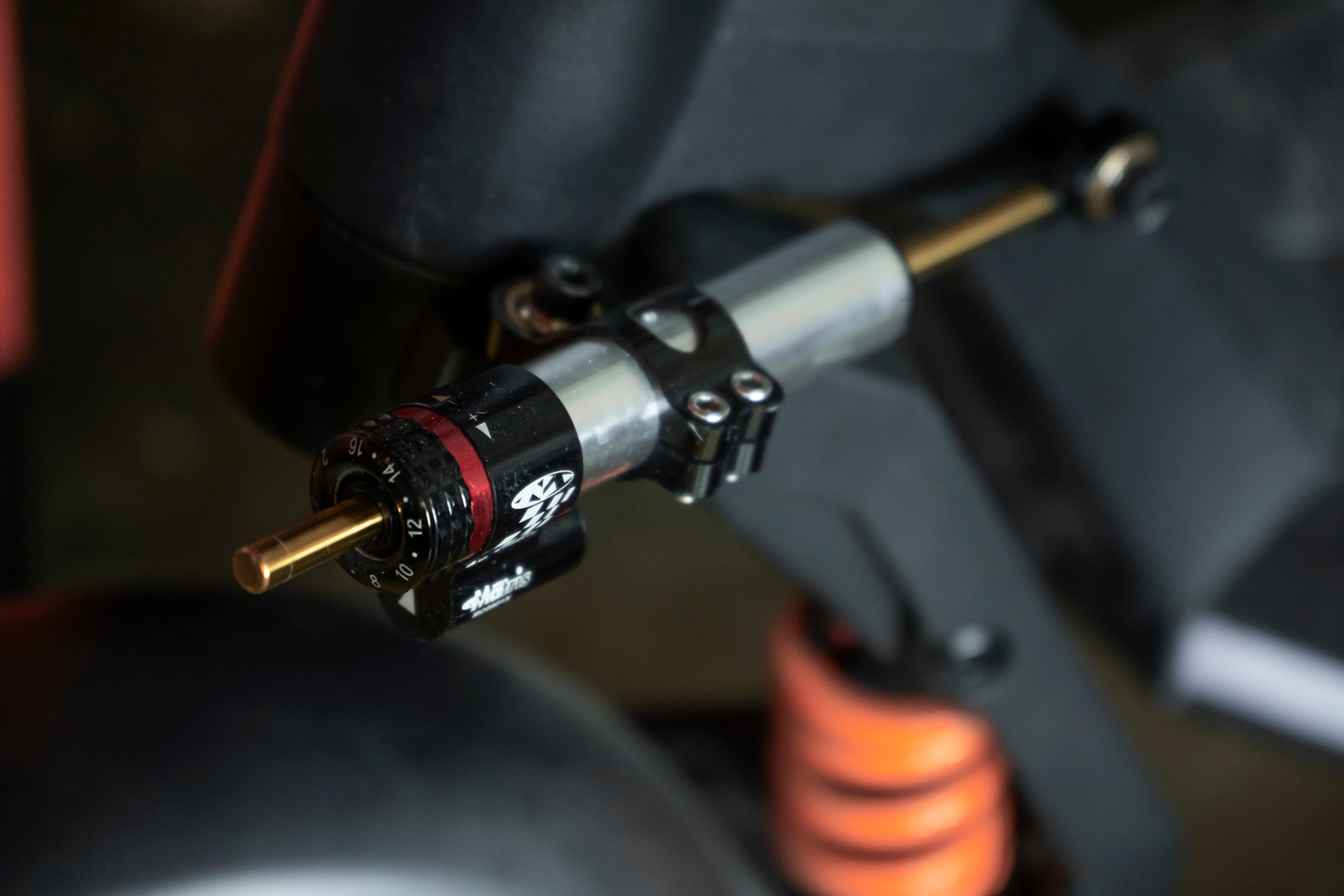 Motorcycle shock absorber with adjustable features, showcasing a dial and markings