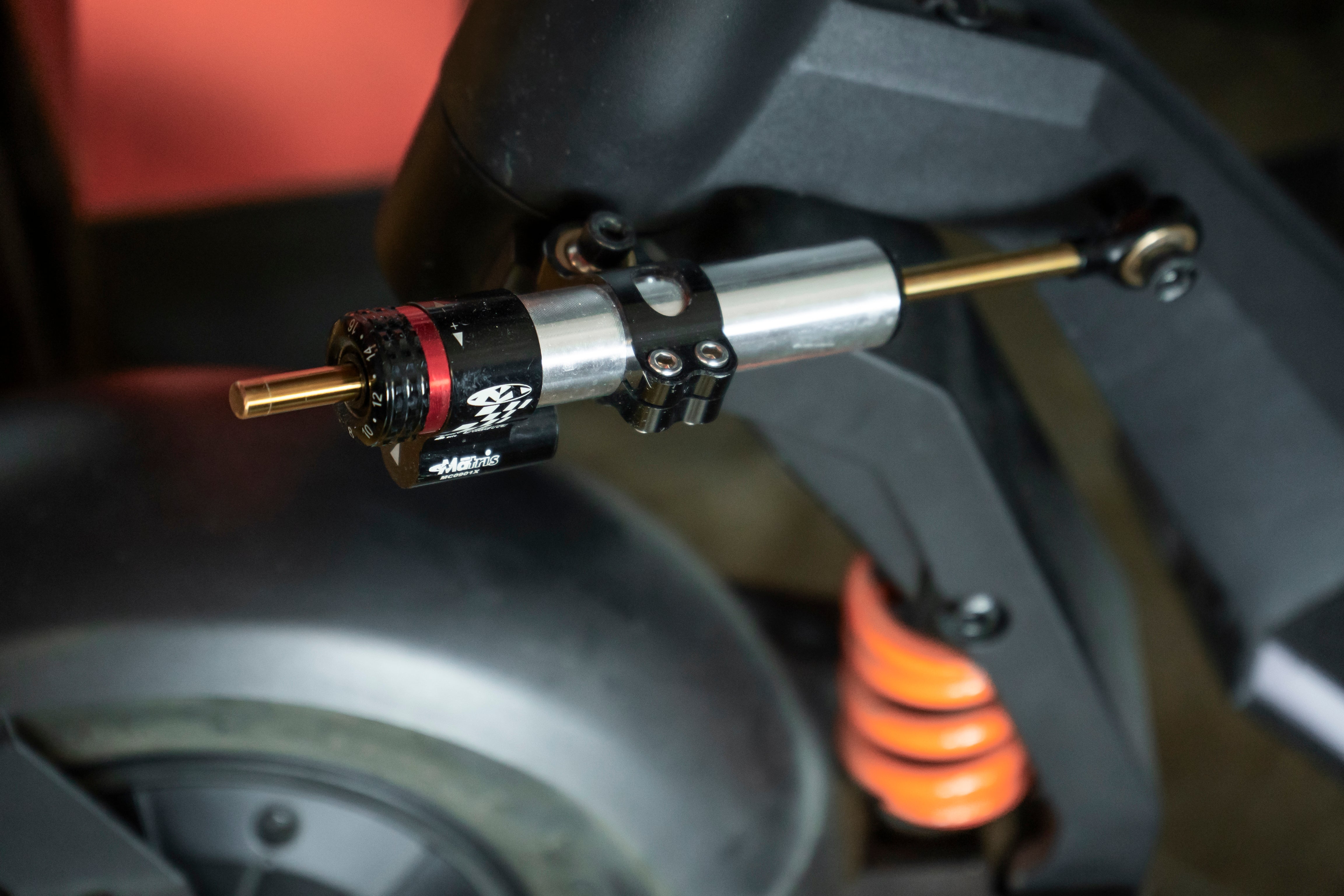 Electric Scooter front suspension with shock absorber, close up view with parts labeled.