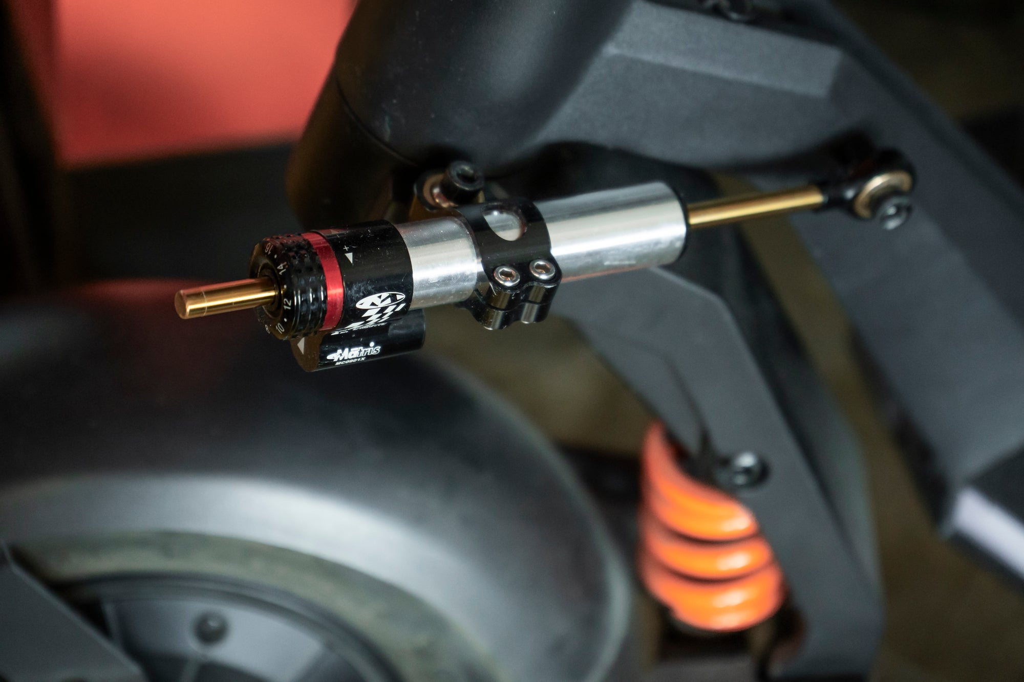 Electric Scooter front suspension with shock absorber, close up view with parts labeled.
