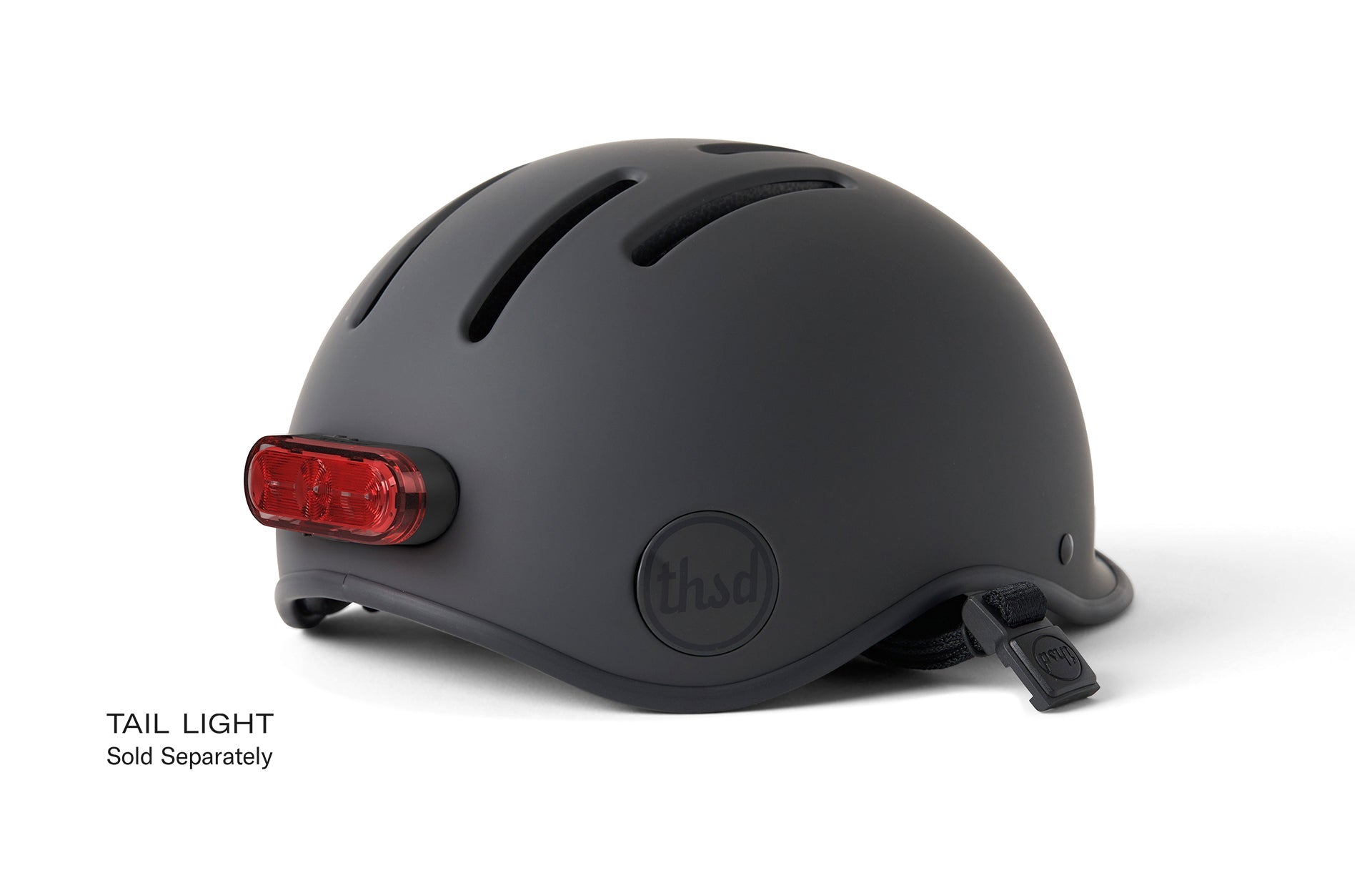 A black bicycle helmet with the words TAIL LIGHT Sold Separately on a white background