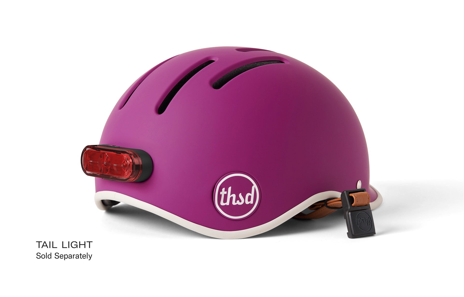 Purple helmet with back reflector and chin strap on a white background.