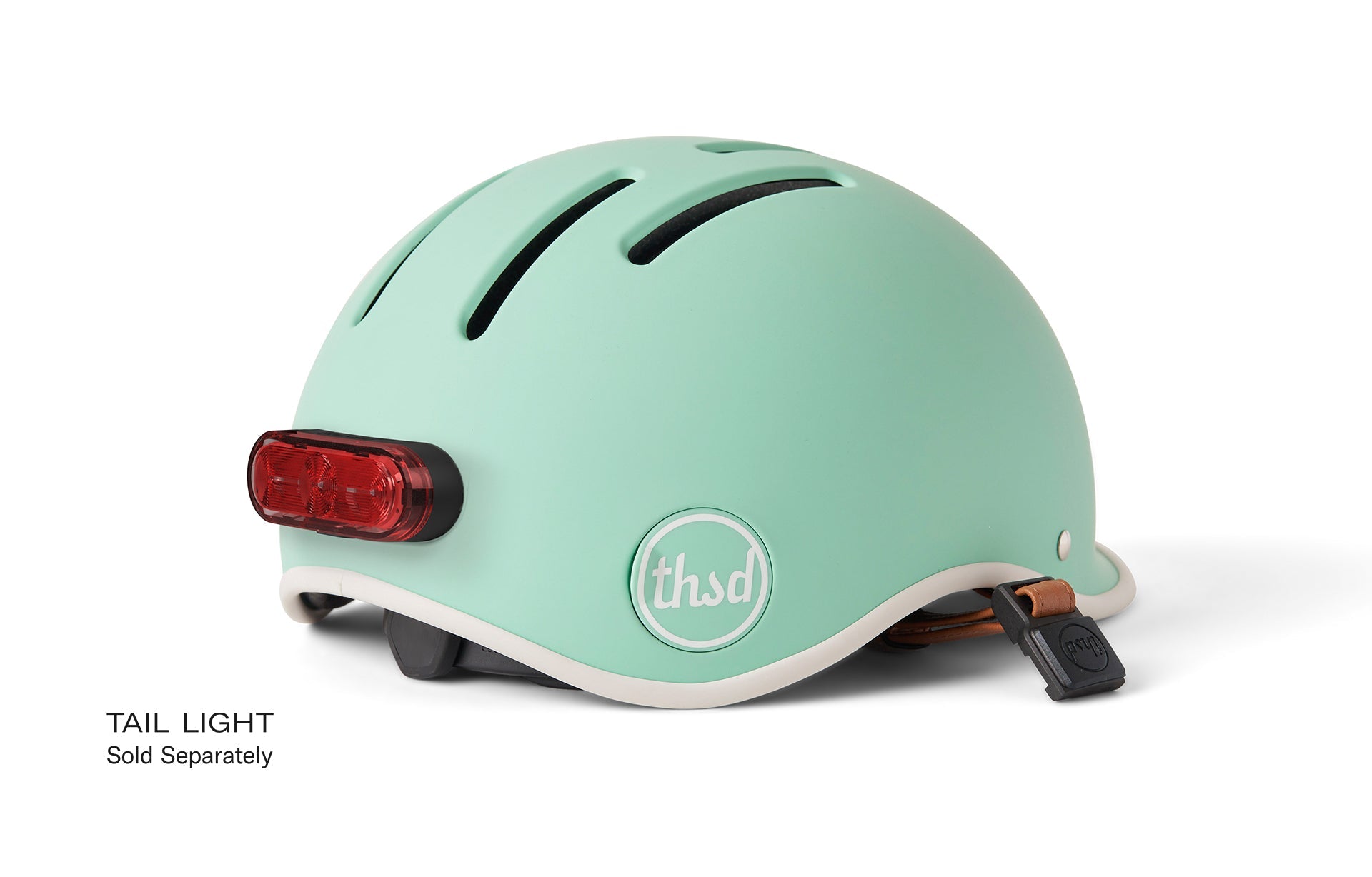 THUSD kids' helmet in pastel green colour with a red back light.