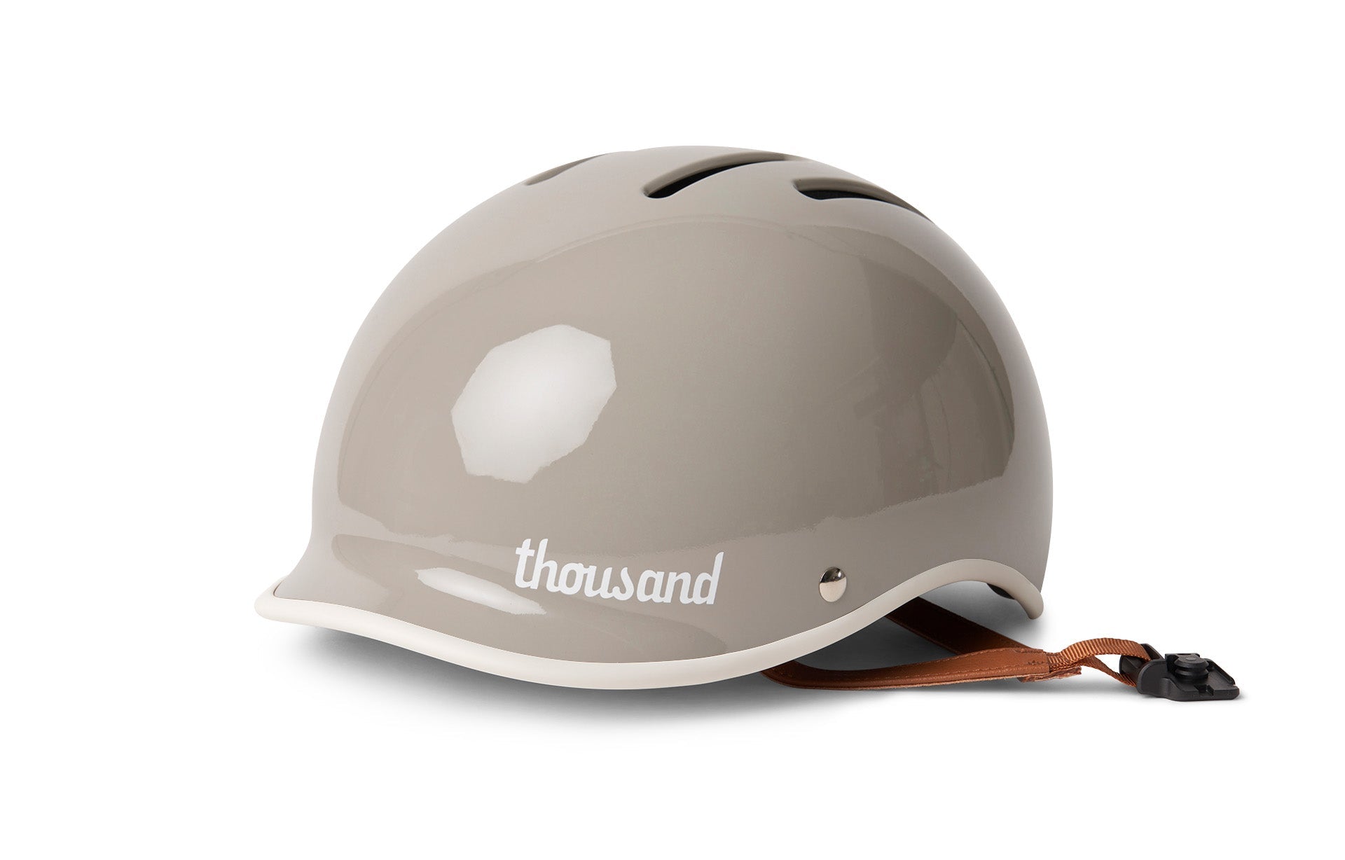 Thousand helmet, side view in gray with white rim, with a brown strap, for cycling, skateboarding, skating.